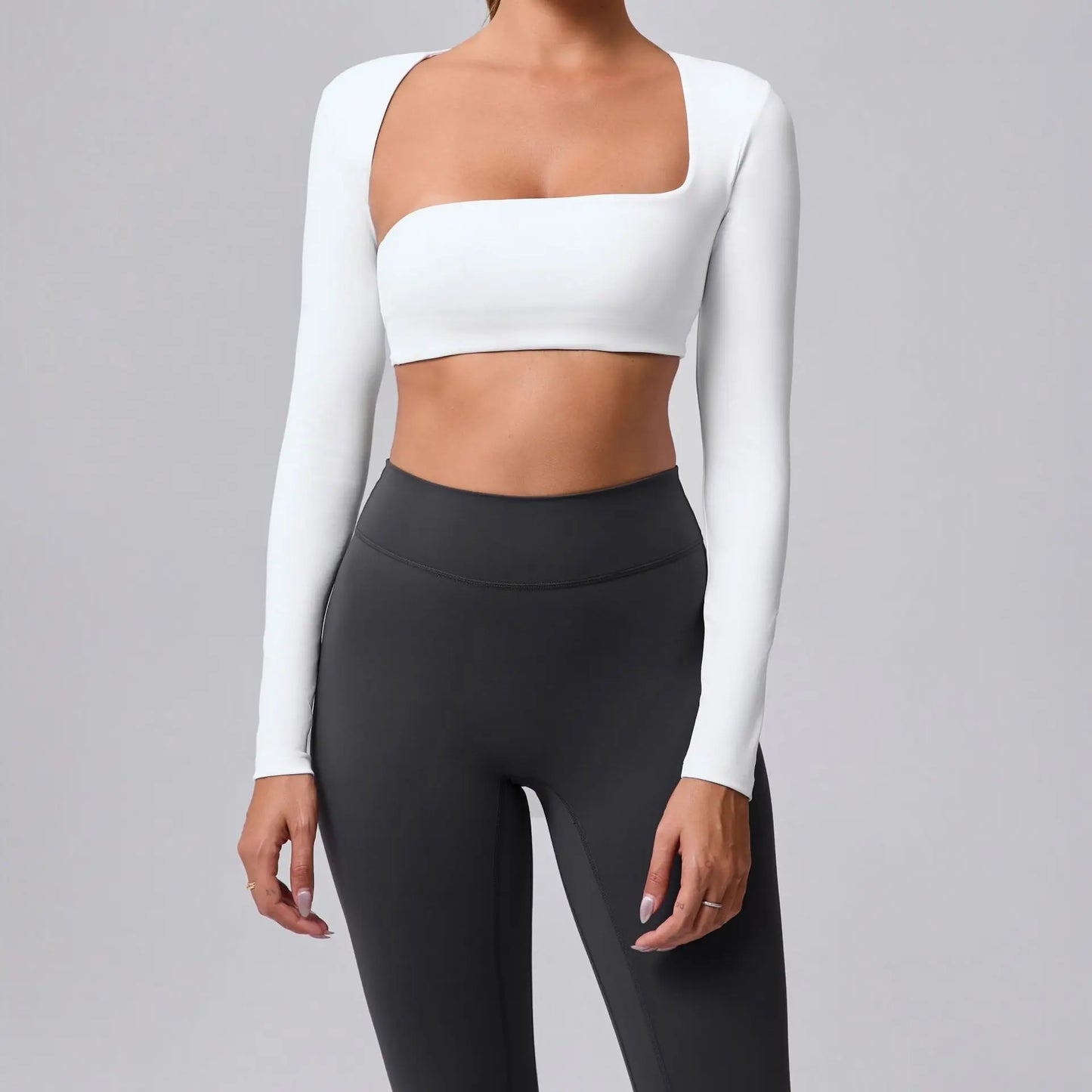Women's sports crop top with square neckline, asymmetric long sleeve, and quick-drying fabric.