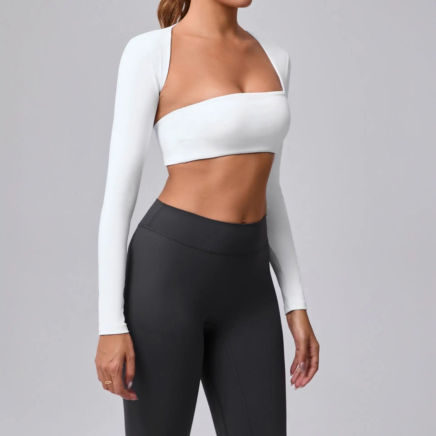 Women's sports crop top with square neckline, asymmetric long sleeve, and quick-drying fabric.