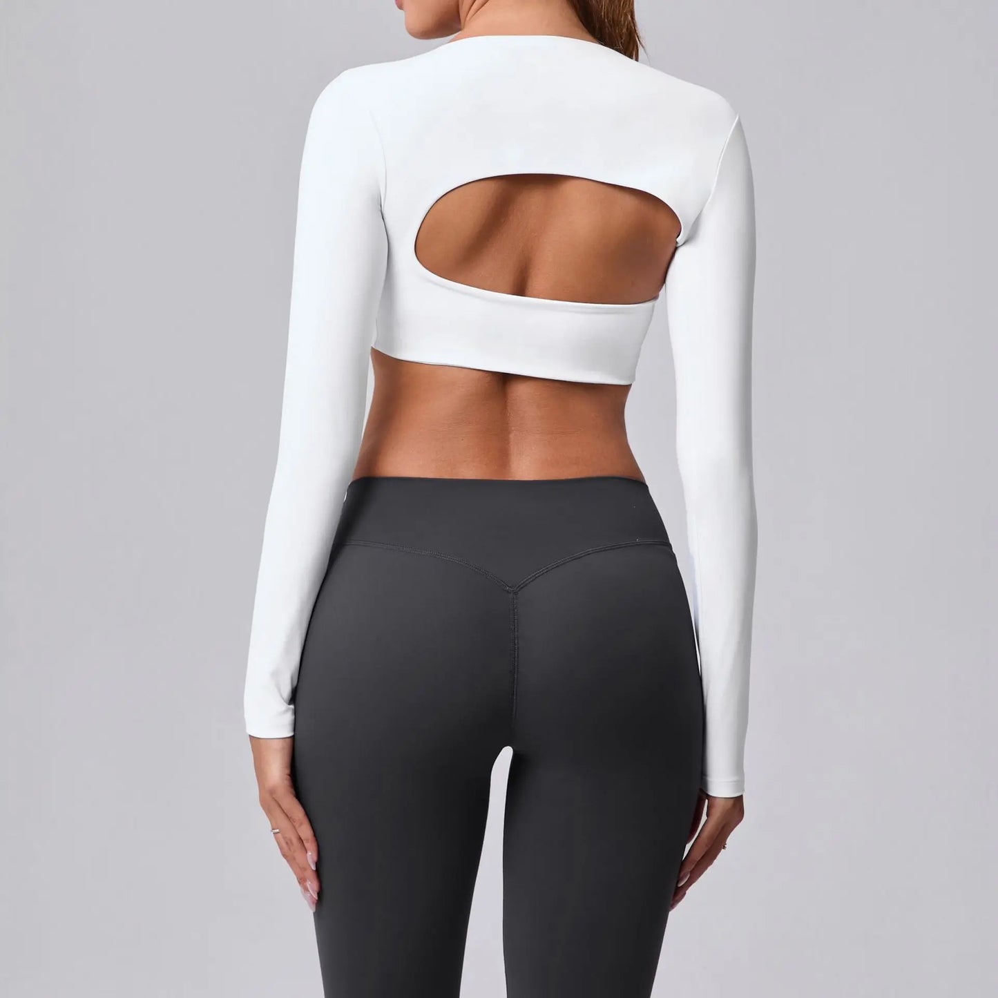 Women's sports crop top with square neckline, asymmetric long sleeve, and quick-drying fabric.