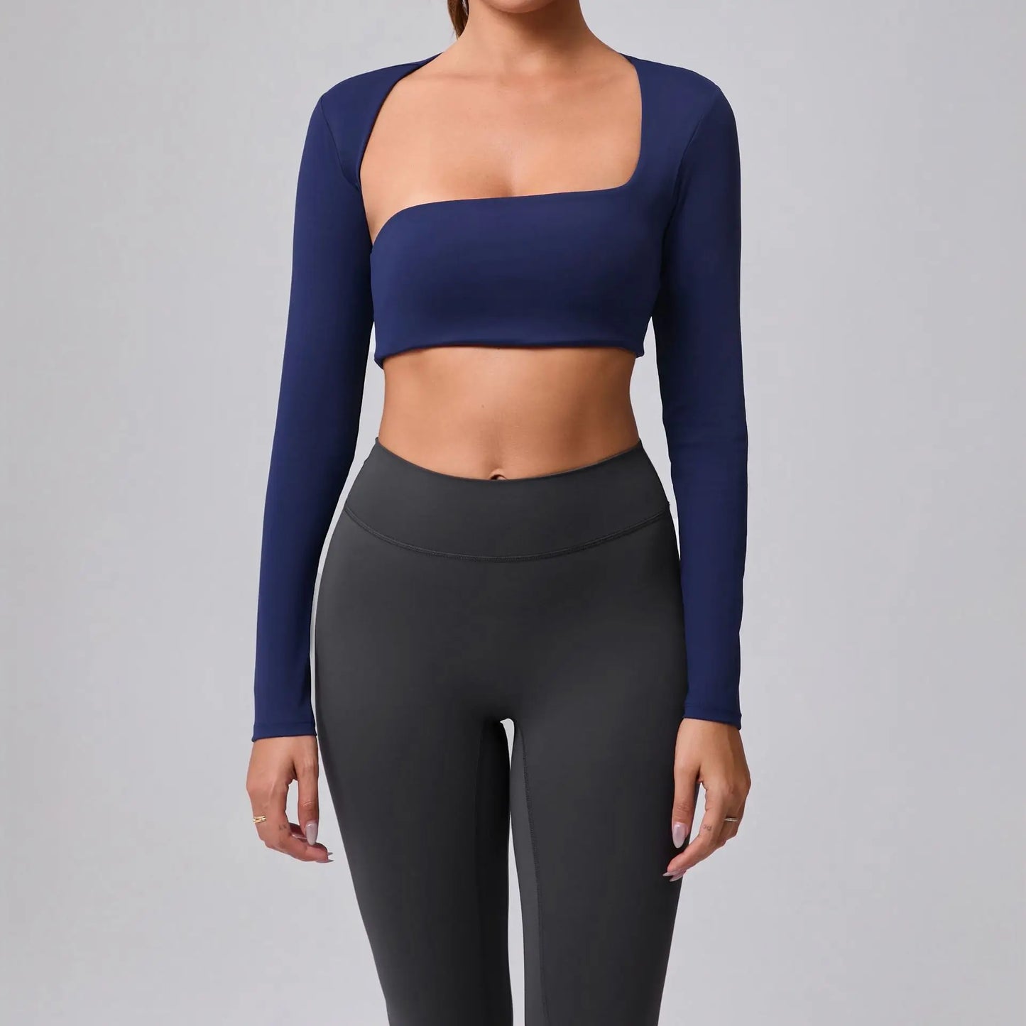 Women's sports crop top with square neckline, asymmetric long sleeve, and quick-drying fabric.