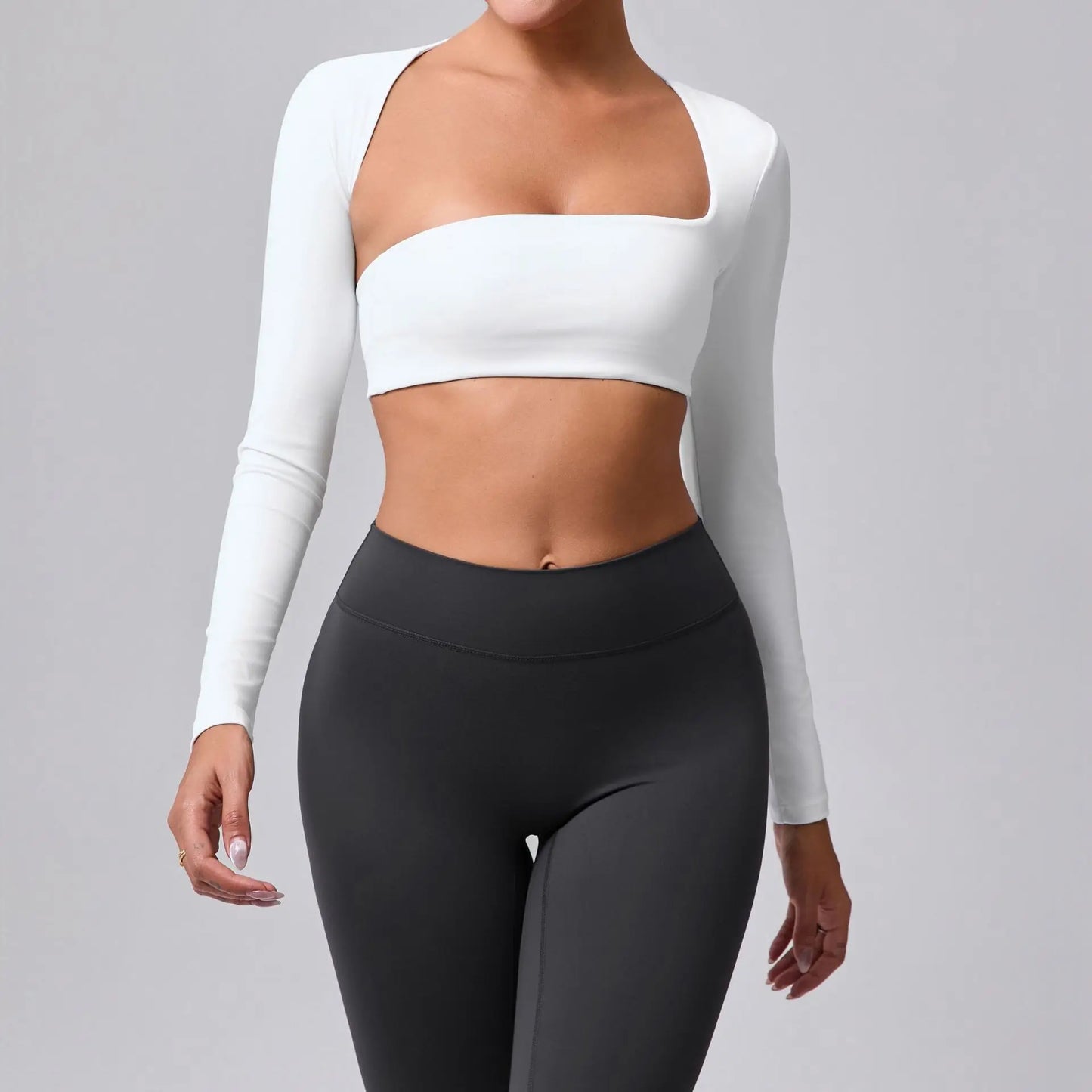 Women's sports crop top with square neckline, asymmetric long sleeve, and quick-drying fabric.